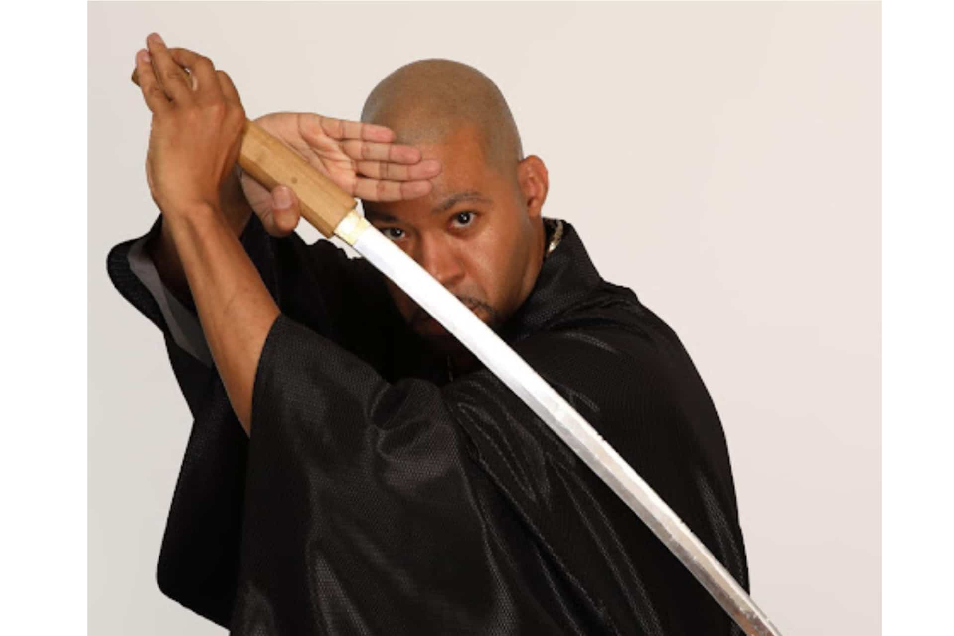 Chuck Johnson wielding a sword-1920x1280